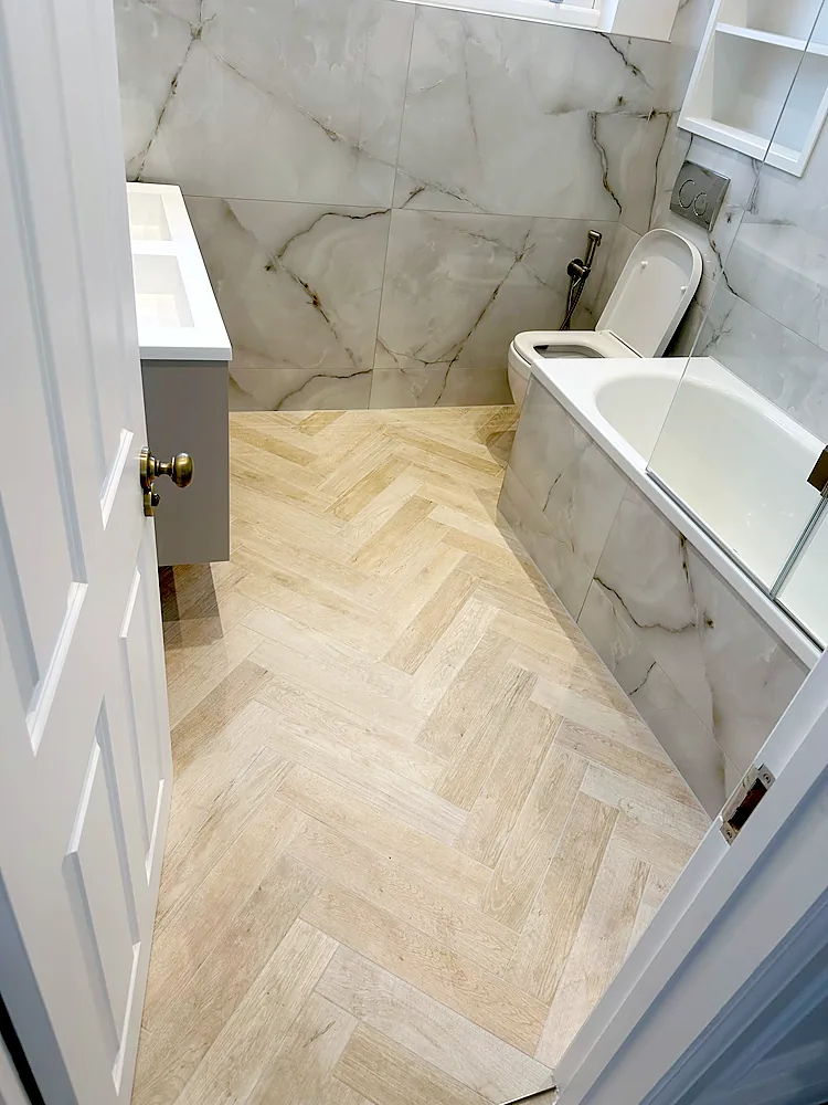 Bathroom marble effect tiles herringbone floor