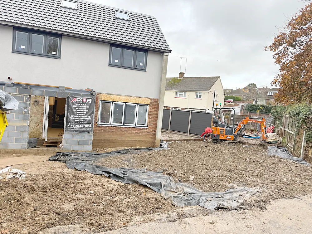 Rear groundworks excavator and Adior site board